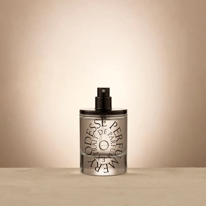 Transparent perfume bottle with black cap and stylized typography of 'ODESSE PARFUM' against a white background, evoking a sense of luxury and elegance in the design. The best Australian made perfumes, affordable natural perfumes. 