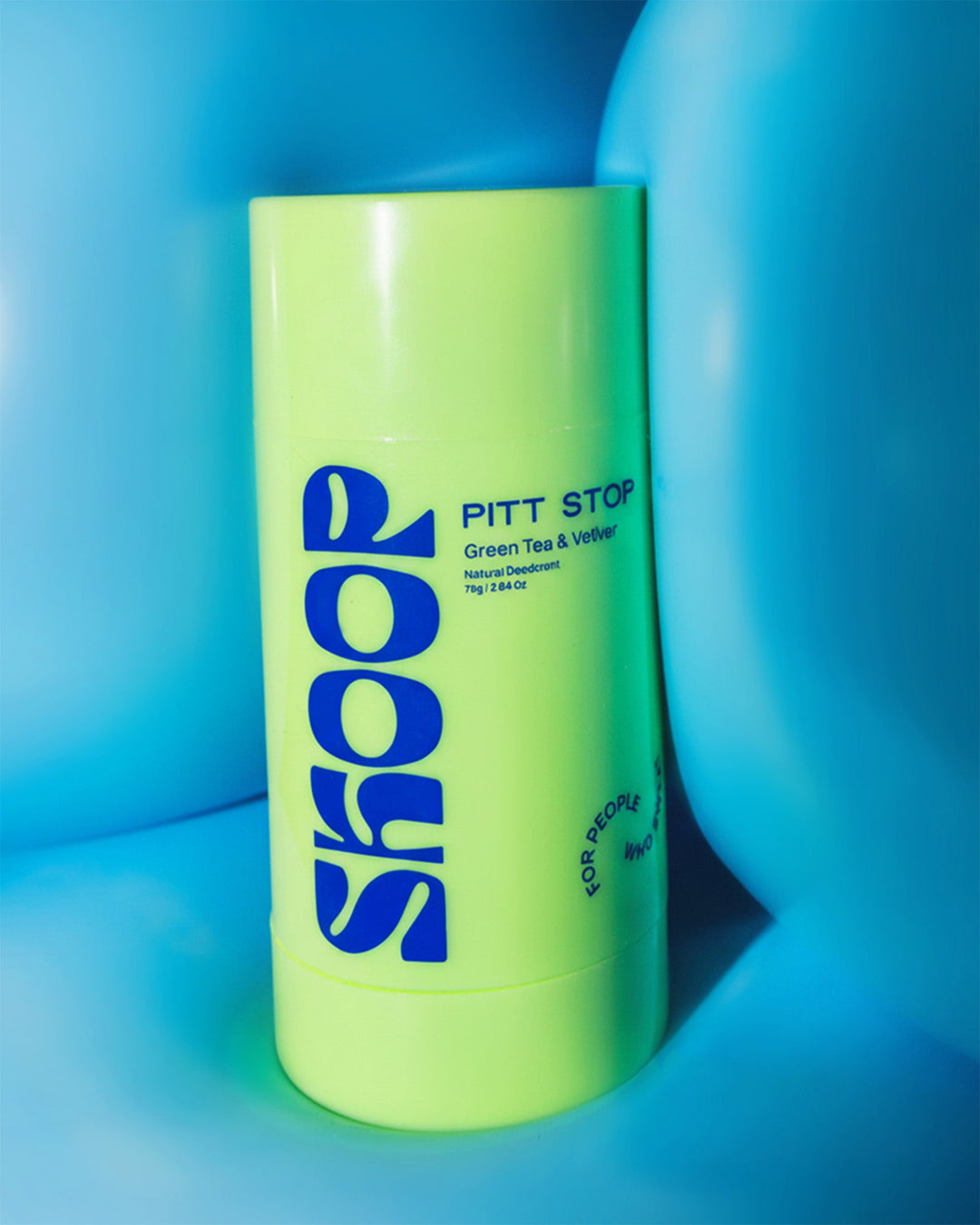Green best natural deodorant for women in a green roll on from Skoop Skincare 'Skoop Pitt Stop' on a blue background