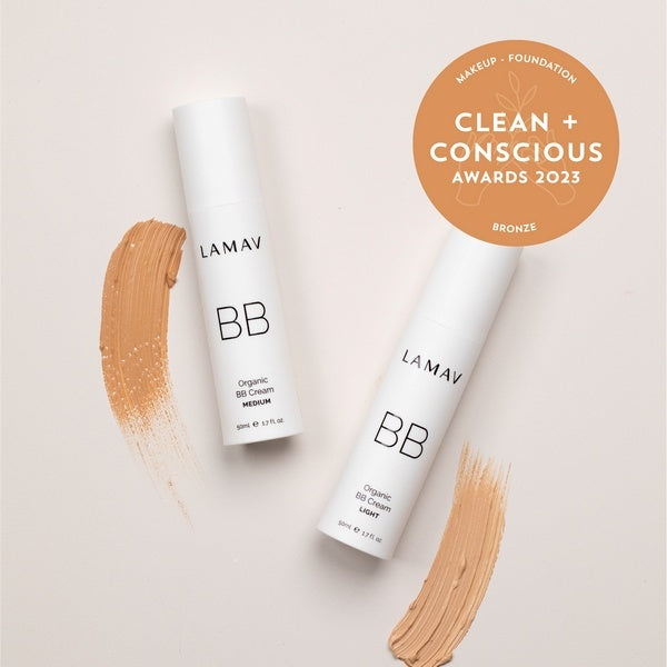Two bottles of LAMAV BB Cream with a bronze 'Clean + Conscious Awards 2023' badge on a beige background.