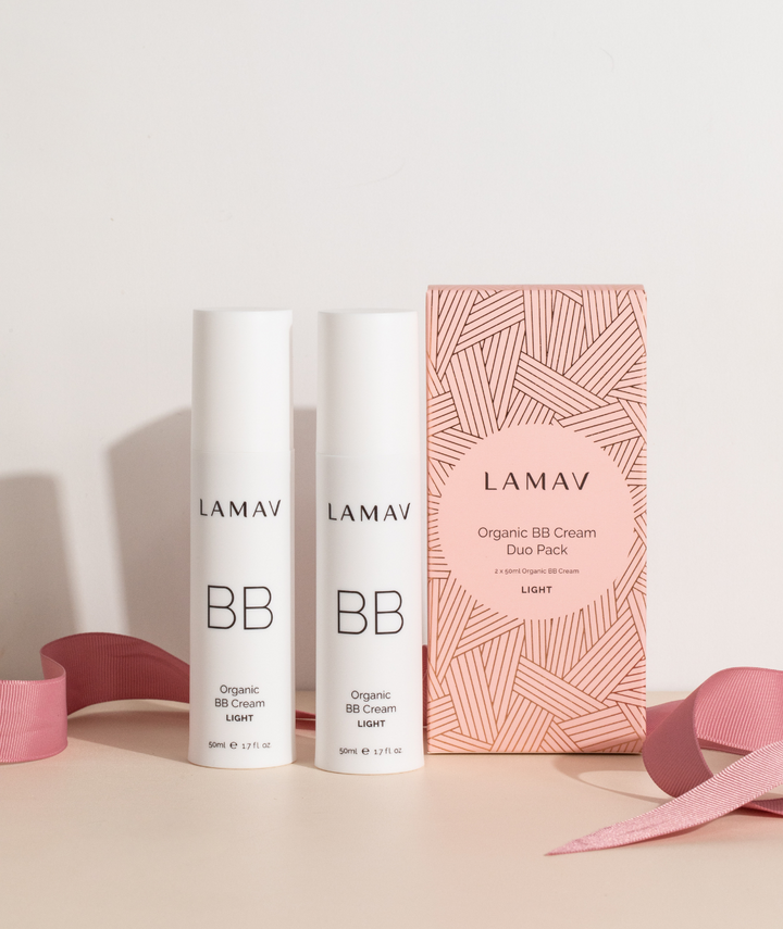 Two LAMAV BB cream bottles and a pink packaging box on a light background