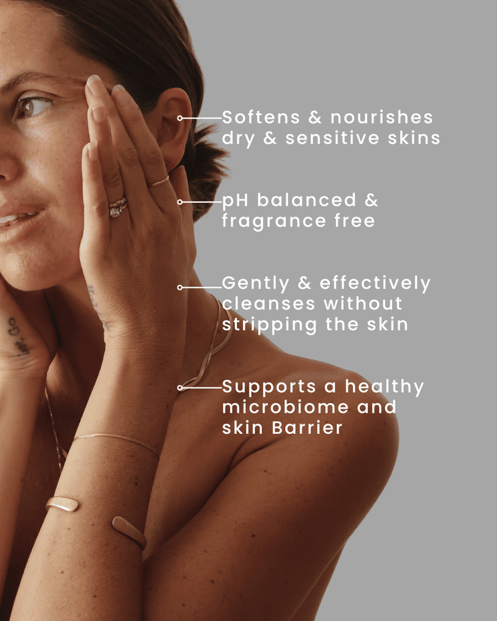 Woman touching her face with text highlighting skincare benefits on a gray background, face wash for sensitive combination skin