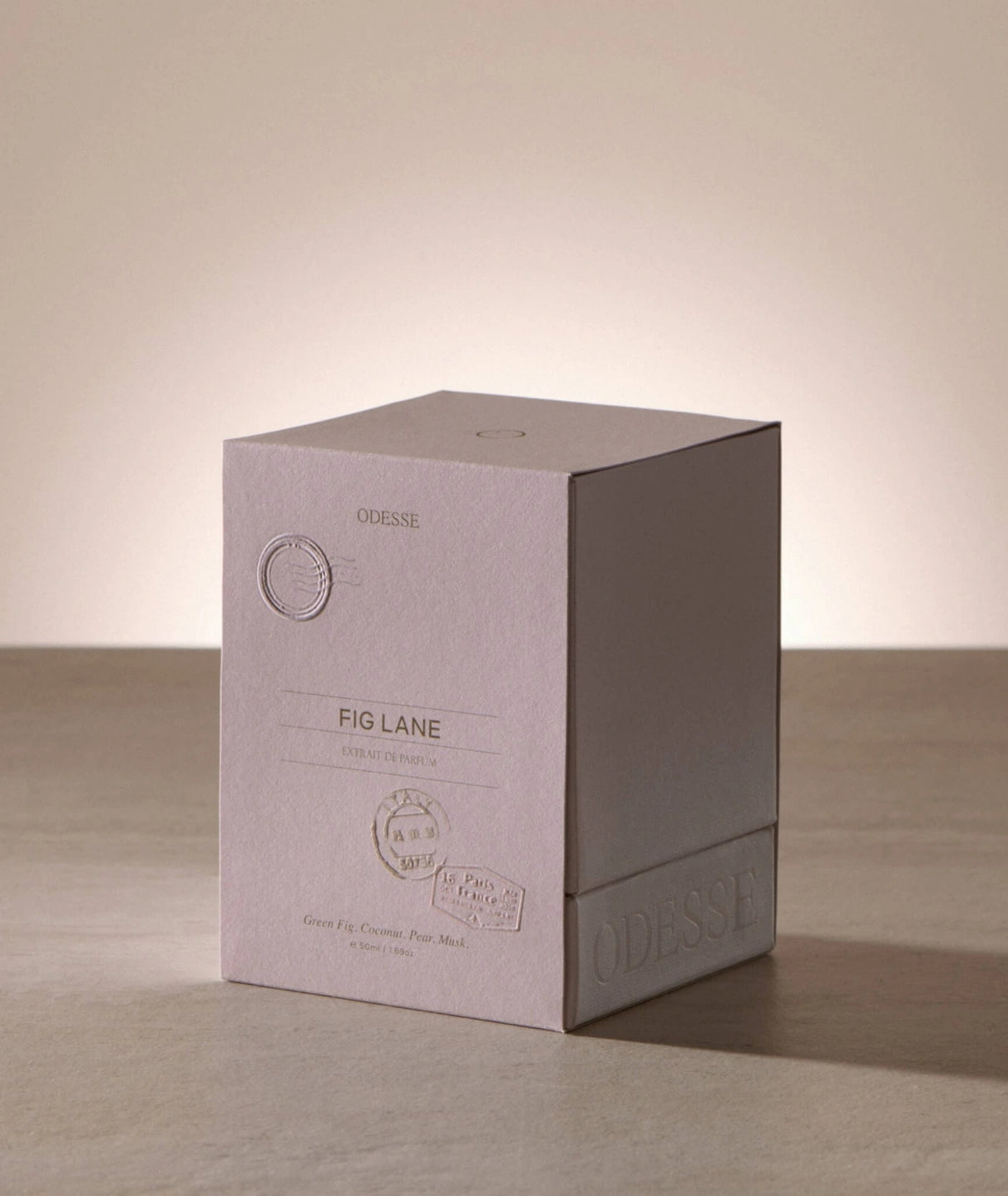 Odesse Fig Lane Extrait de Parfum luxury perfume packaging featuring embossed blush-toned box inspired by Parisian travel, with notes of green fig, coconut, pear and musk.