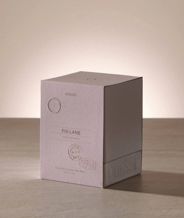 Odesse Fig Lane Extrait de Parfum luxury perfume packaging featuring embossed blush-toned box inspired by Parisian travel, with notes of green fig, coconut, pear and musk.