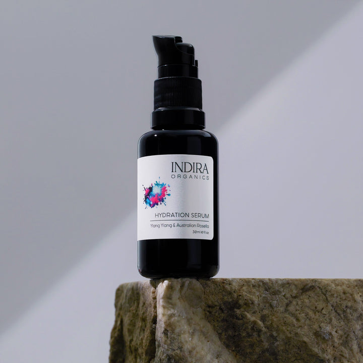 hydrating organic facial serum on a stone