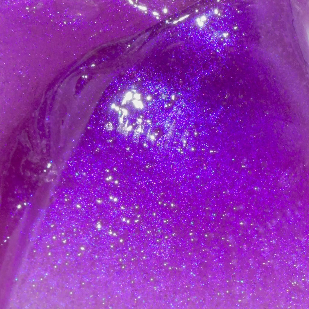 Close-up of the vibrant purple, shimmering jelly texture of Muse by Gaia’s Nightbloom Exfoliating Jelly Balm showing its luxurious, glow-enhancing formula with salicylic acid, squalane and nourishing oils.
