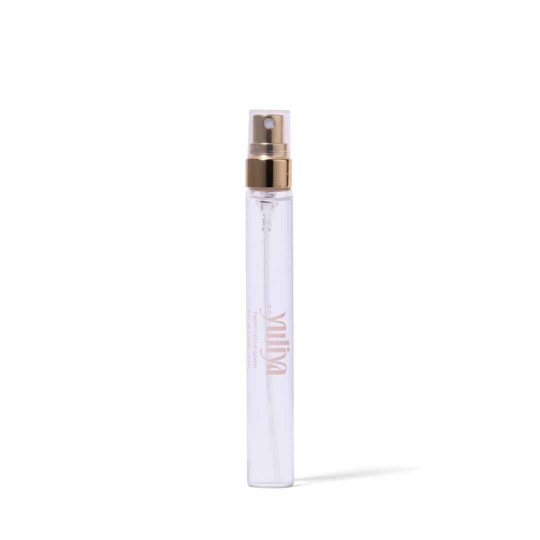 Clear spray bottle with gold cap on a white background