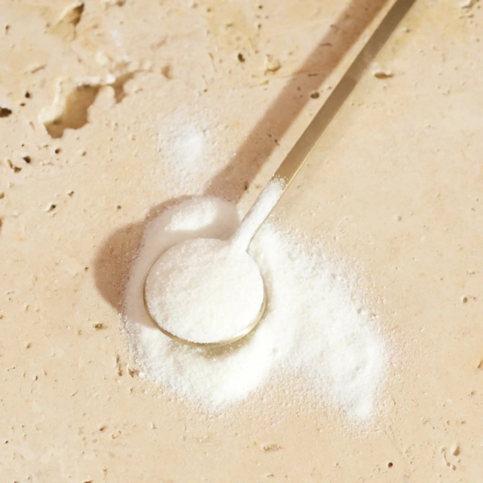 Close-up of Innour natural collagen powder on a spoon, highlighting the fine, premium marine collagen formula for glowing skin and overall wellness.