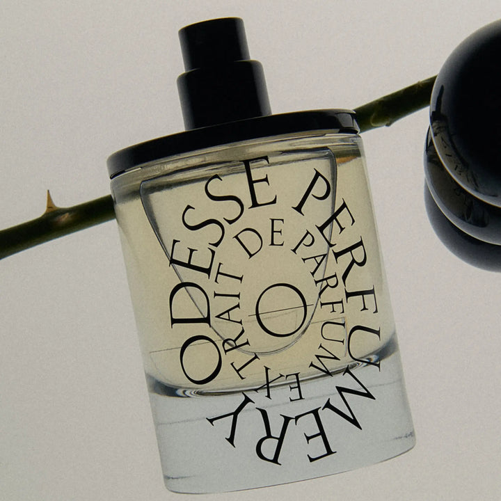 Odesse perfume poised with a dynamic reflection, hinting at luxury and elegance for Australian fragrance lovers.