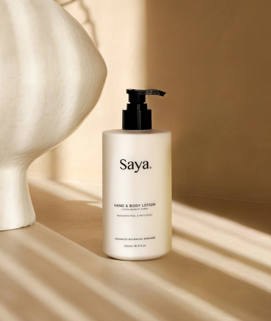 Saya Hand & Body Lotion (Mandarin & Patchouli). Botanical shower essentials in a white pump.