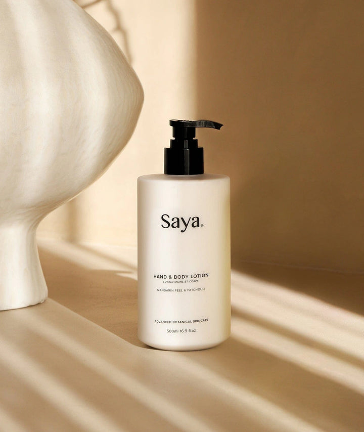 Saya Hand & Body Lotion (Mandarin & Patchouli). Botanical shower essentials in a white pump.
