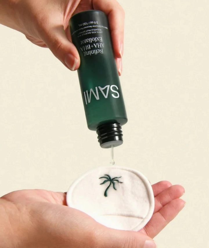 Refining AHA + BHA Exfoliator by SAMI — liquid formula pouring onto a reusable cotton pad