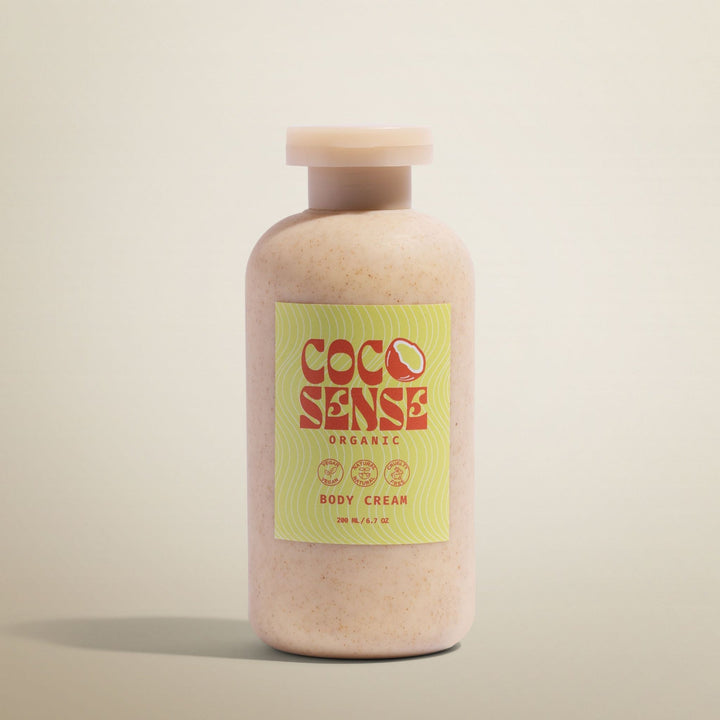 Coco Sense organic body cream bottle on a beige background