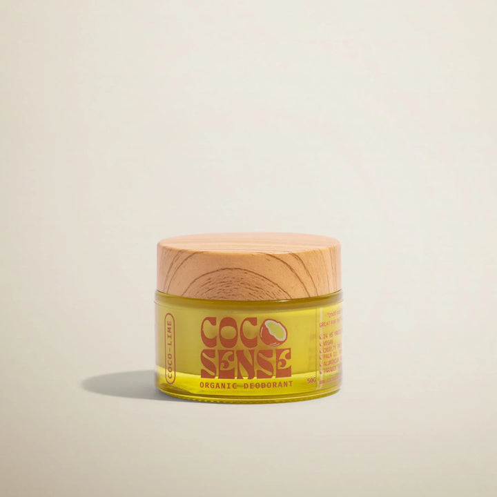 Jar of Coco Sense organic deodorant on a beige background