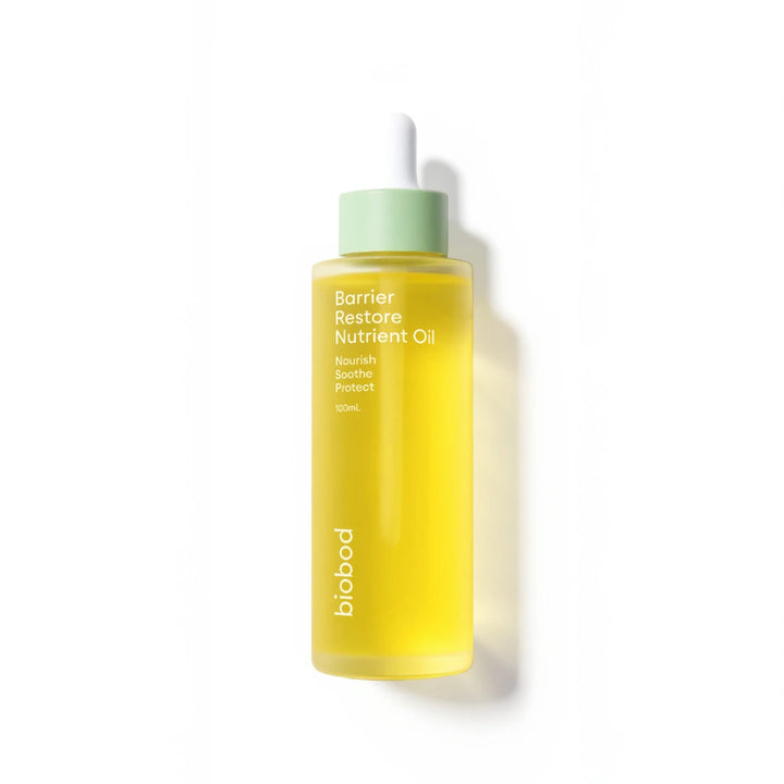 Yellow bottle of face oil for acne prone skin with green cap on a white background, featuring 'Bestseller' label and awards.