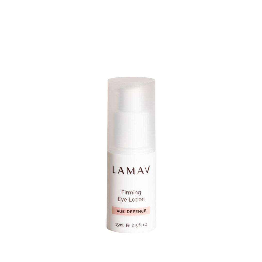Bottle of LAMAV Organic Firming Eye Lotion, part of the AGE-DEFENCE line, 15ml. The product is presented in a sleek, white dispenser with clear labeling, designed for reducing the appearance of fine lines around the eyes.