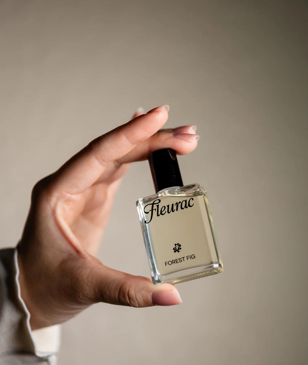 Fleurac Forest Fig Perfume — Hand holding clear glass spray bottle | Fresh botanical eau de parfum