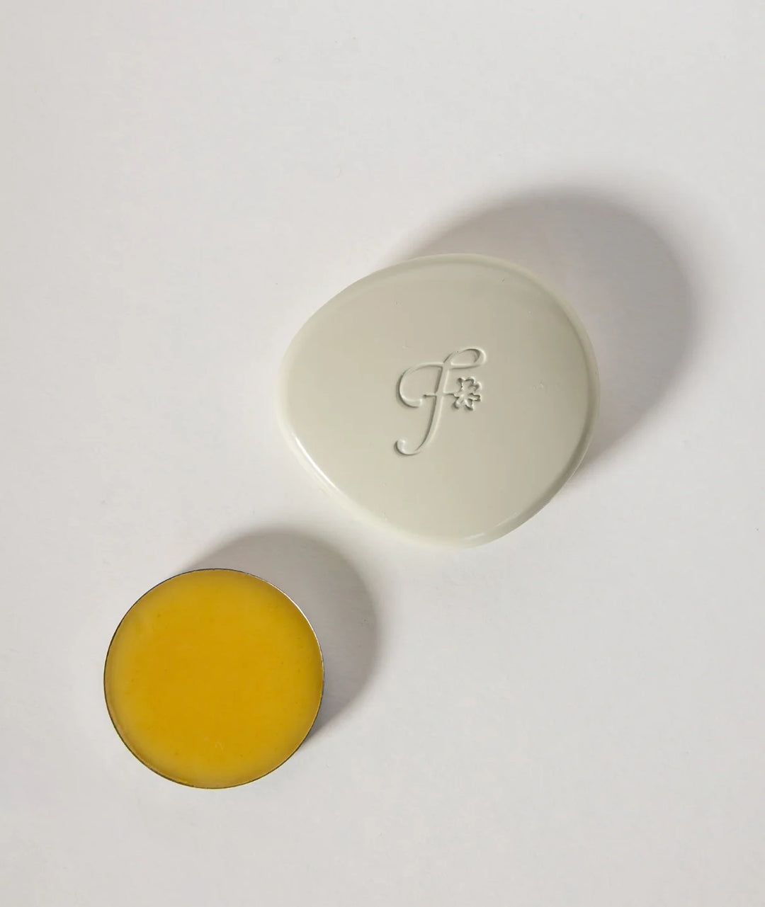 Fleurac Woodpetal Solid Perfume — Open pebble compact case with yellow balm refill | Natural solid fragrance