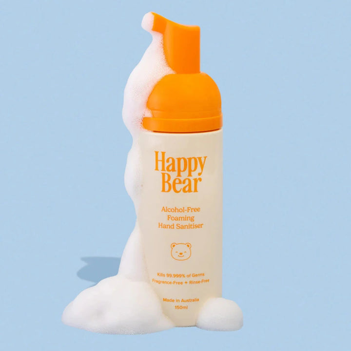 Happy Bear alcohol-free foaming hand sanitizer bottle with orange pump on a light blue background