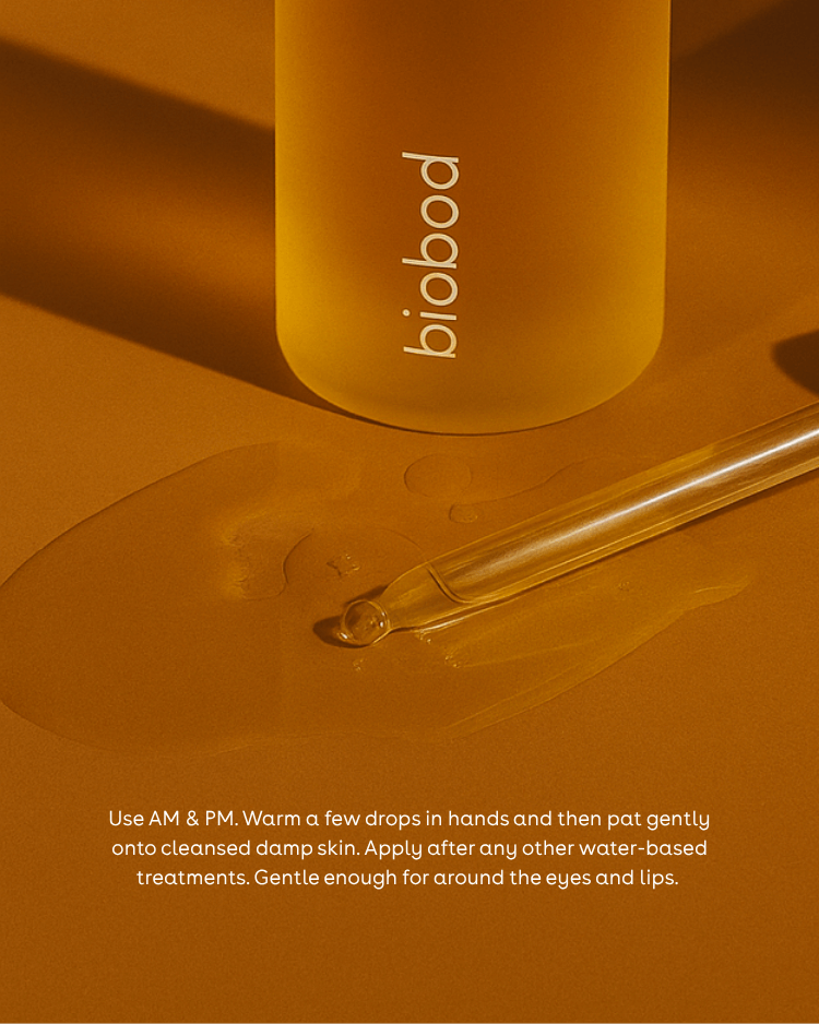 Face oil for acne prone skin bottle and dropper on a warm brown background with product usage instructions.