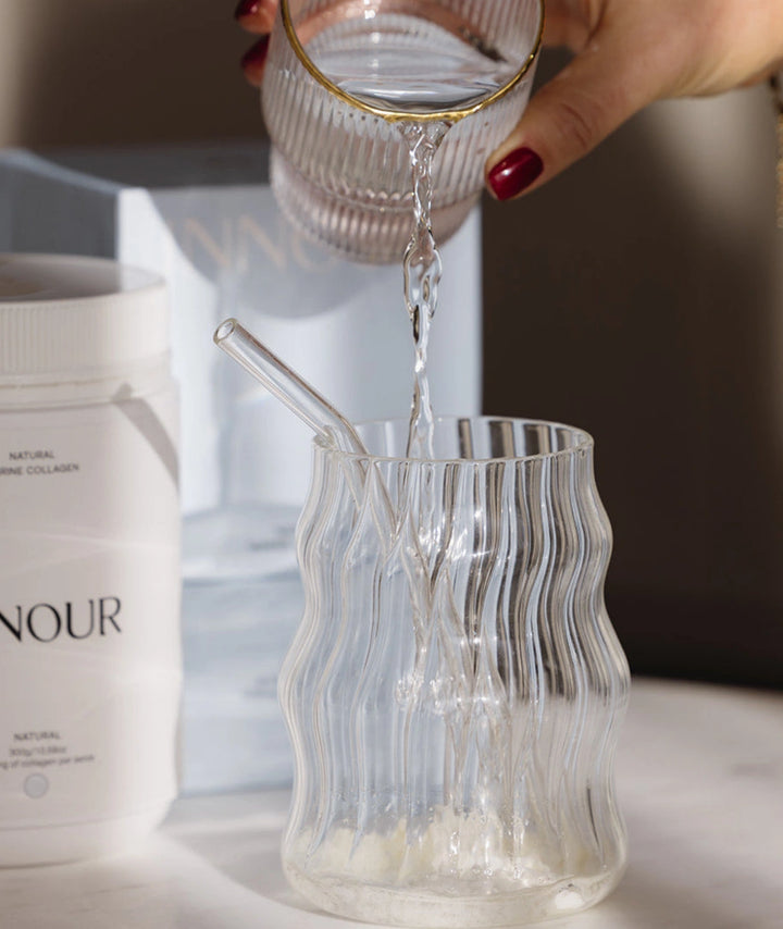 Preparing Innour Natural Marine Collagen 150g by adding water to collagen powder, creating a daily beauty supplement drink for skin hydration and wellness support.