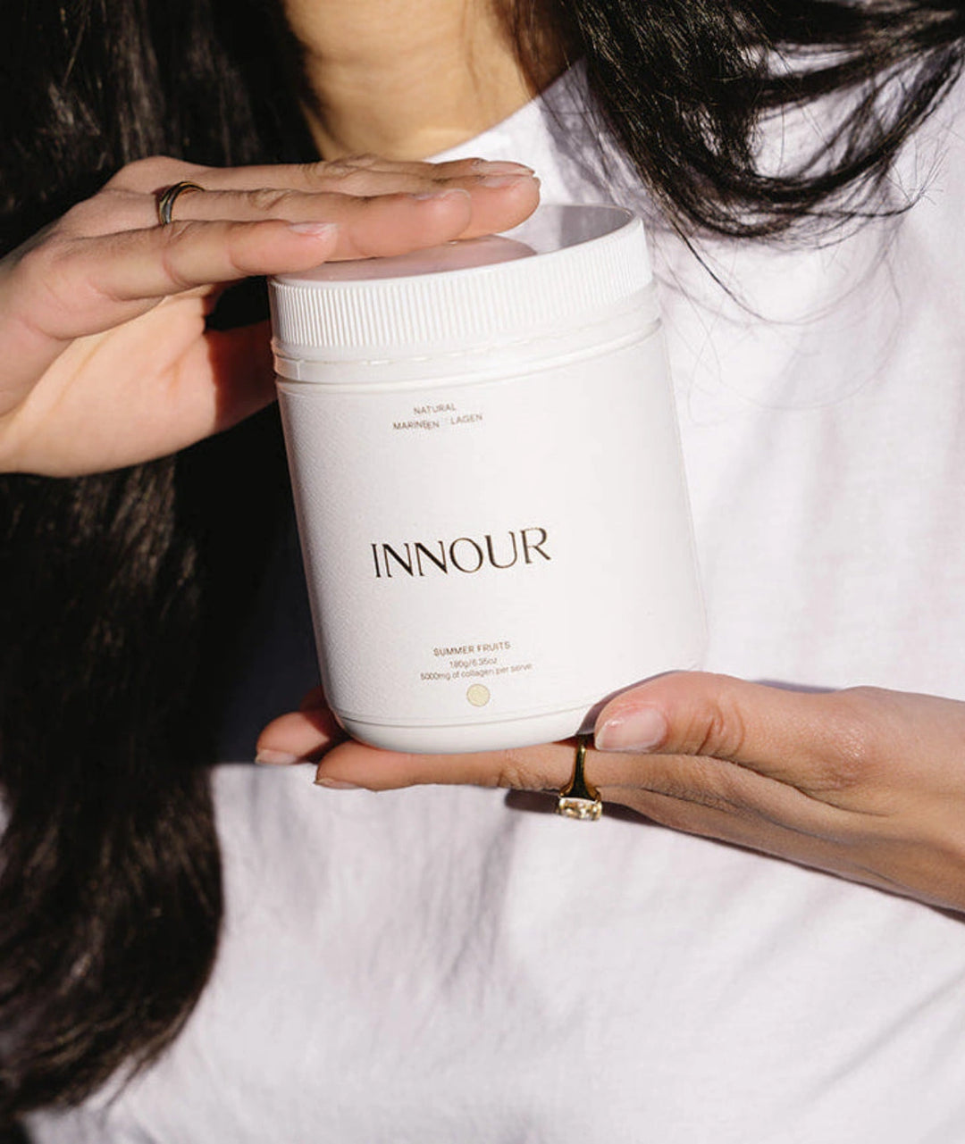 Innour Natural Marine Collagen Summer Fruits 180g held by model highlighting premium marine collagen supplement for healthy skin, hair and nail