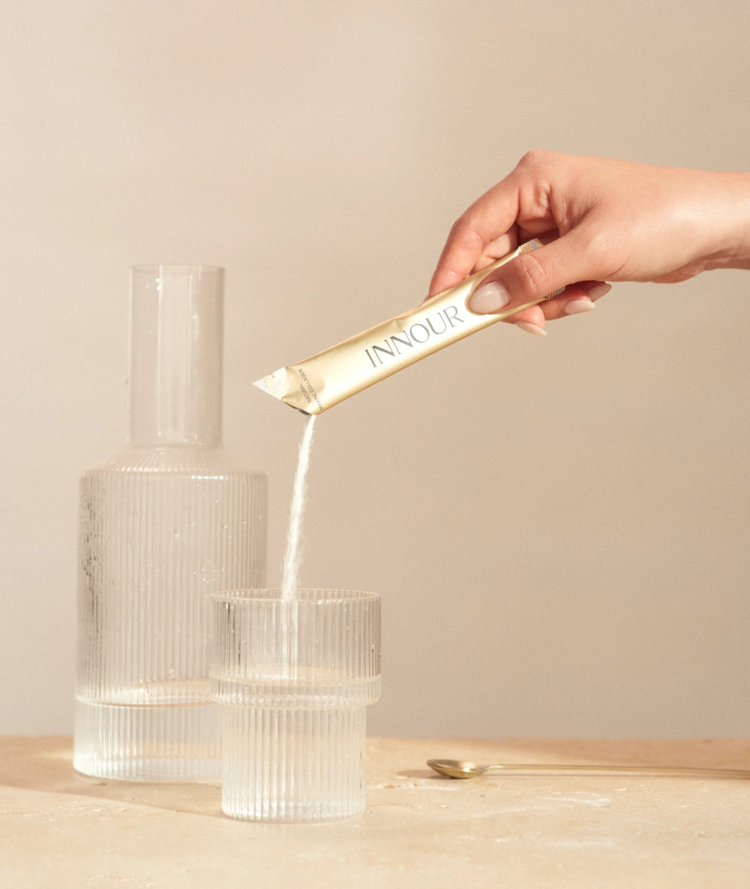 Innour Natural Marine Collagen Summer Fruits sachet being added to water, creating a convenient daily collagen drink for beauty and wellness support.