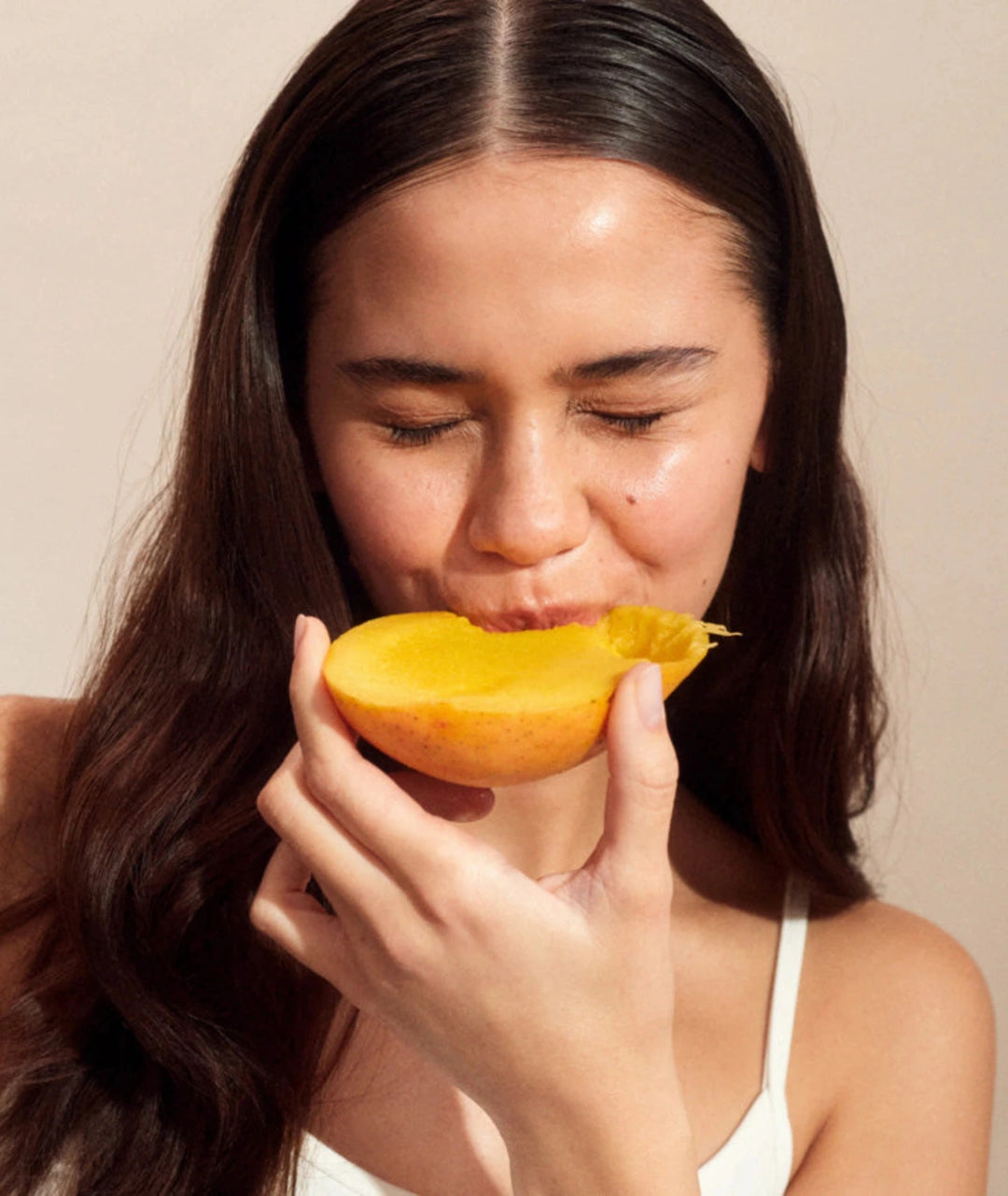 Woman enjoying fresh summer fruit representing the natural summer fruits flavour of Innour Marine Collagen powder for daily beauty and wellness routines.