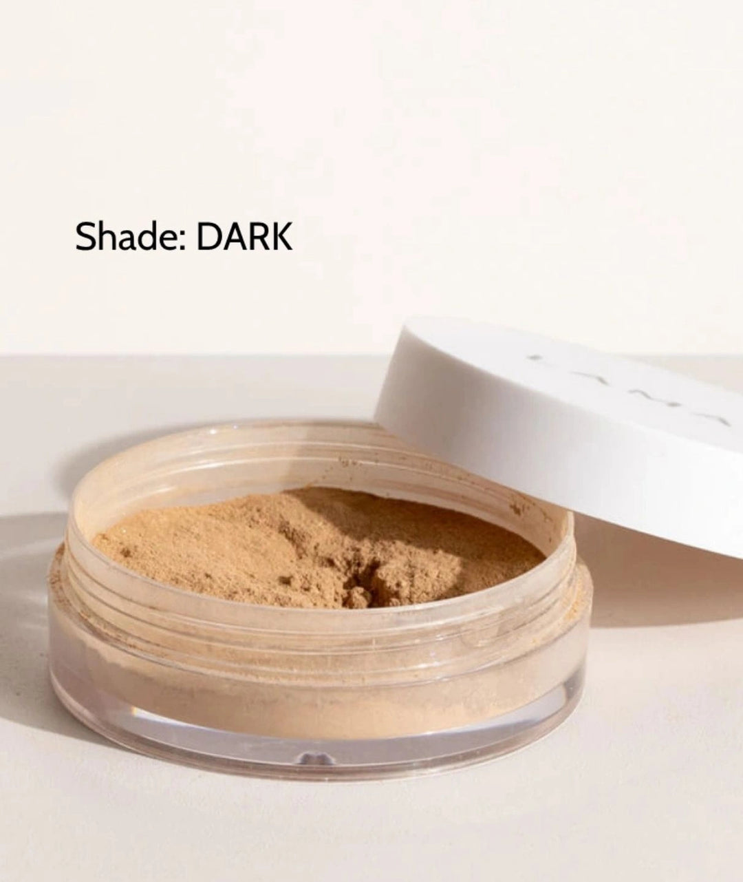 LAMAV Anti-Ageing Mineral Foundation SPF15 in Dark shade. Organic powder foundation isolated on a minimal surface.