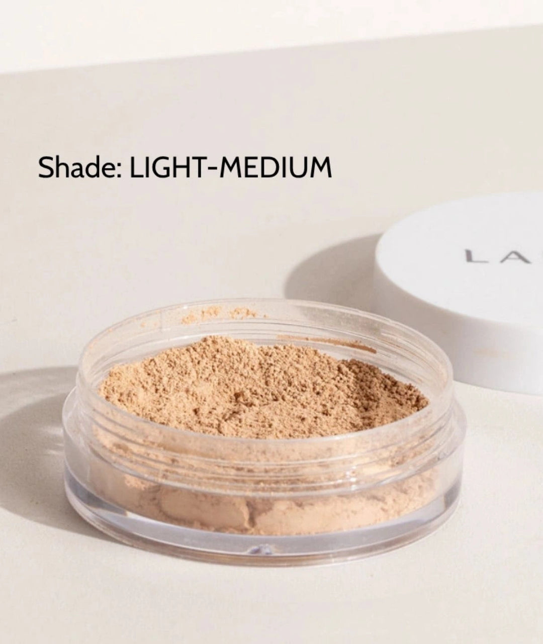 LAMAV Anti-Ageing Mineral Foundation SPF15 in Light-Medium shade. Vegan powder makeup in an open jar.