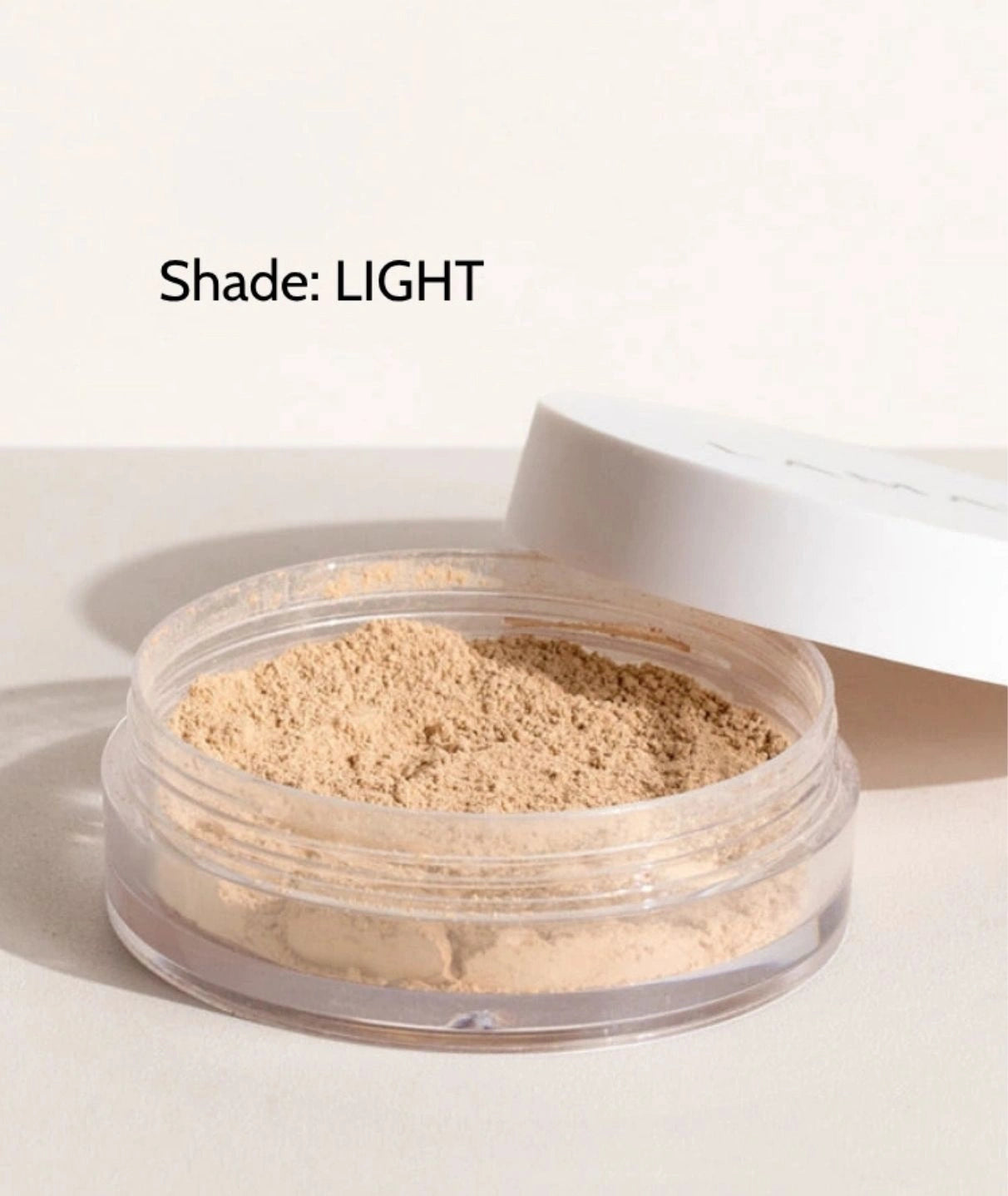 LAMAV Anti-Ageing Mineral Foundation SPF15 in Light shade. Open jar of brightening mineral powder.