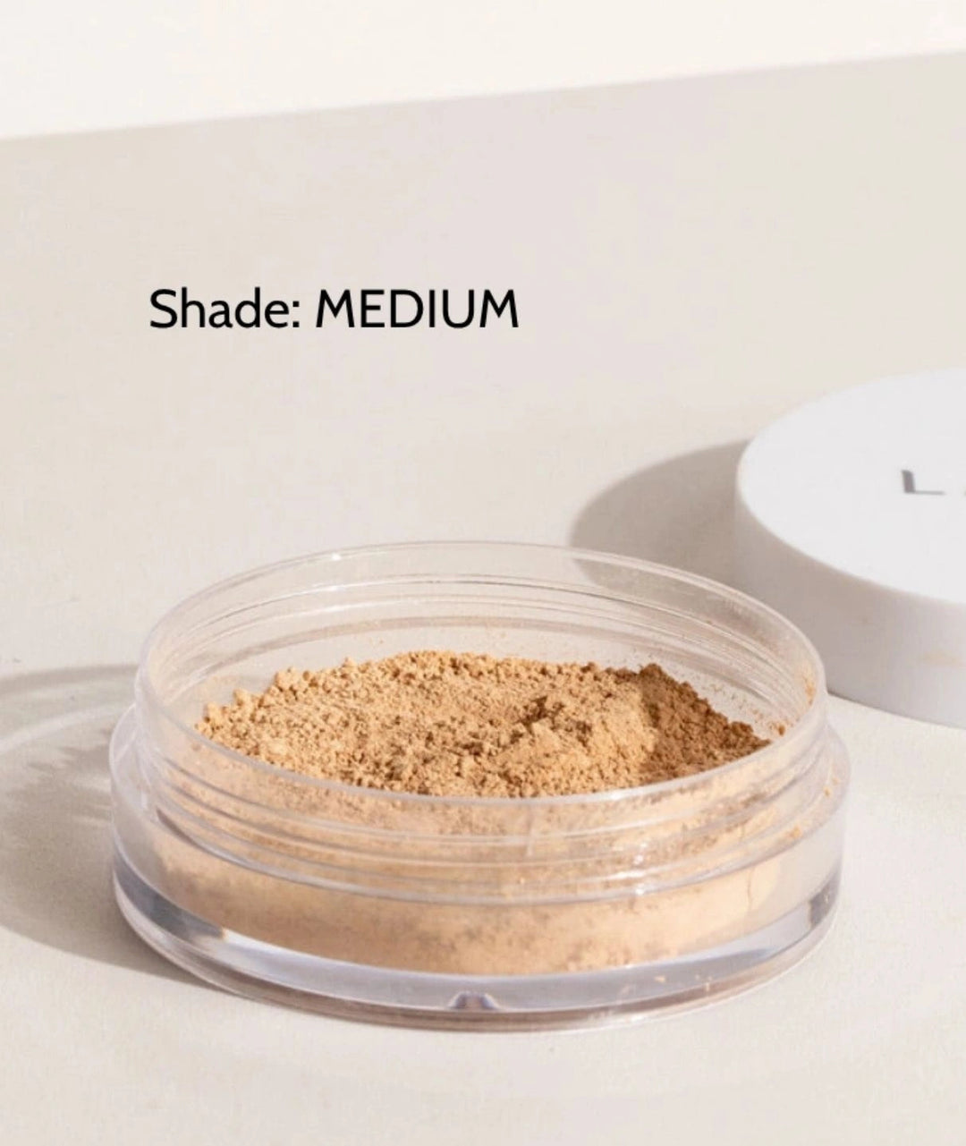 LAMAV Anti-Ageing Mineral Foundation SPF15 in Medium shade. Open cosmetic jar of natural powder foundation.