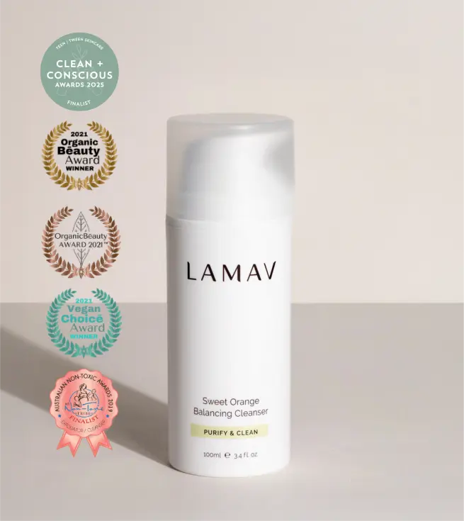 Woman using LAMAV Sweet Orange Balancing Cleanser as part of a daily skincare routine for oily and acne-prone skin.