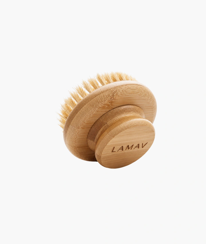 Round wooden LAMAV dry body brush with natural bristles on a white background.