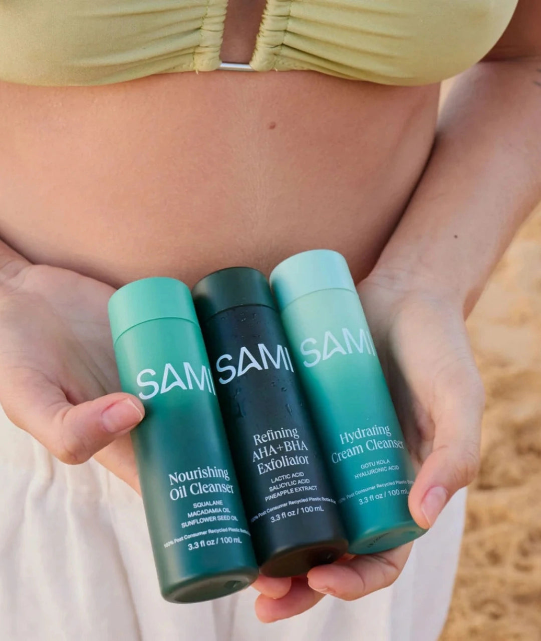 SAMI Skincare Products by LAMAV — three bottles held in hands at the beach, showing ingredient labels | natural skincare