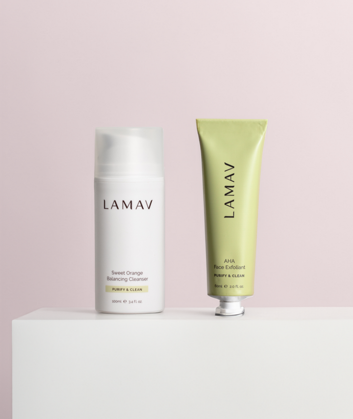 LAMAV Cleanse and Polish Pack standing on a white display block. Purifying facial cleanser and AHA exfoliant.