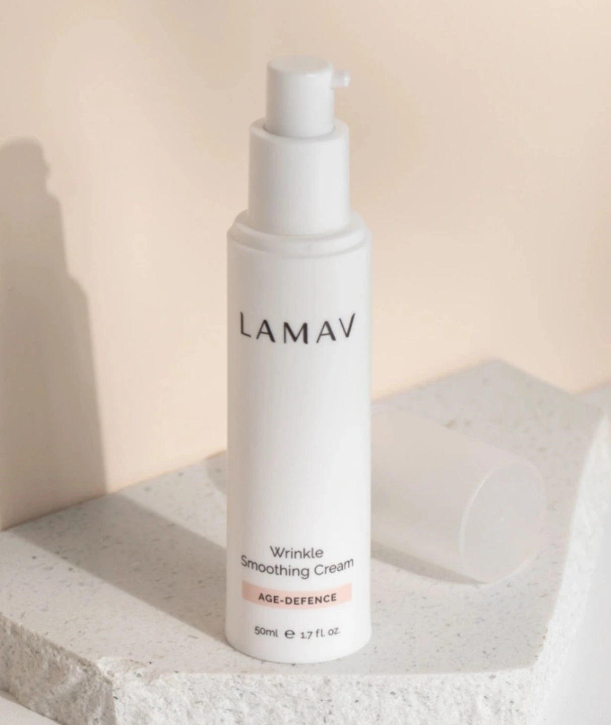 LAMAV Wrinkle Smoothing Cream 50ml on a stone display. Age-defence skincare pump bottle for fine lines.
