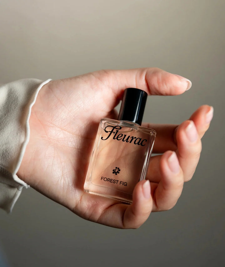 Forest Fig Perfume by Fleurac — Hand holding clear glass spray bottle | Fresh woody botanical eau de parfum