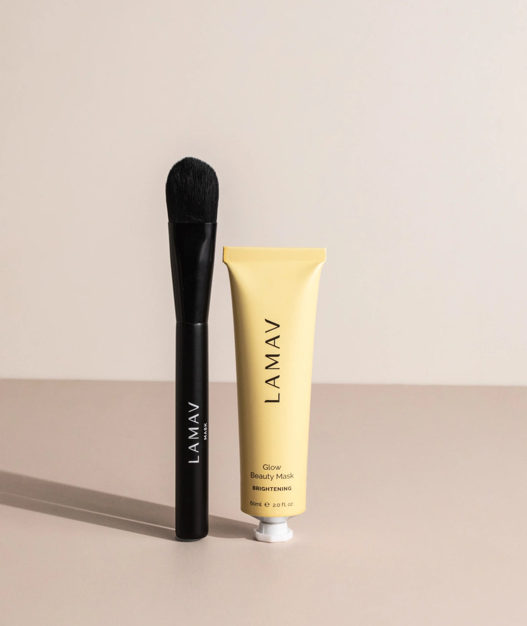 LAMAV organic face mask tube and brush on a beige background