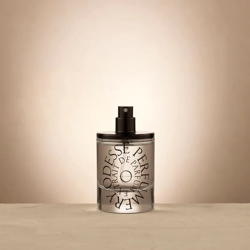 Transparent perfume bottle with black cap and stylized typography of 'ODESSE PARFUM' against a white background, evoking a sense of luxury and elegance in the design. The best Australian made perfumes, affordable natural perfumes