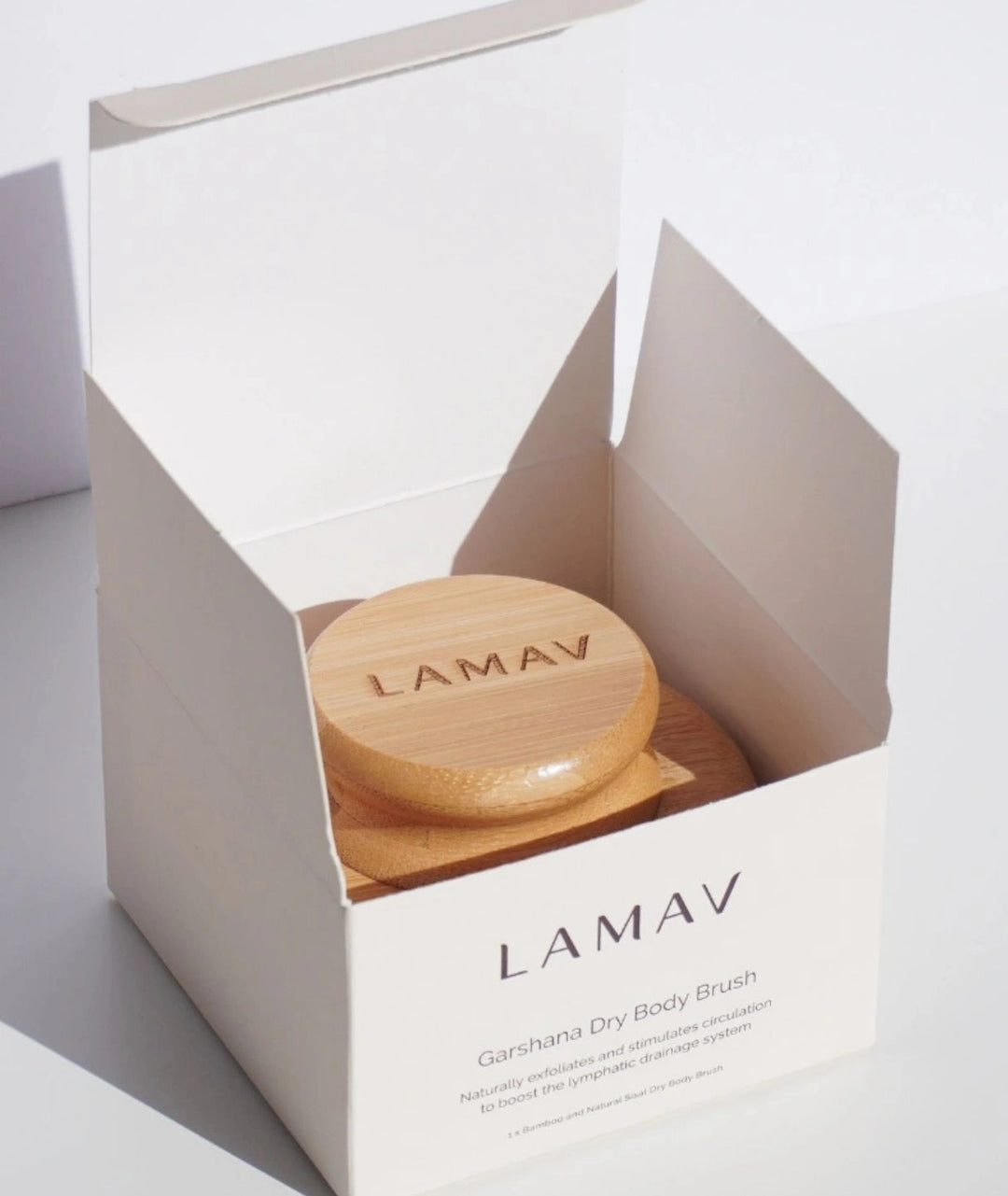 LAMAV Garshana Dry Body Brush resting inside its open white packaging box.