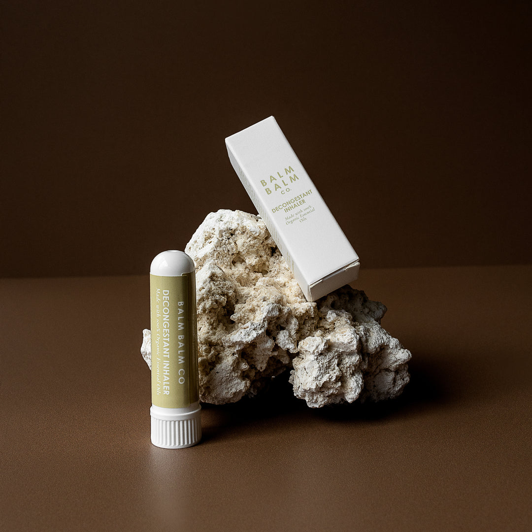 Balm Balm Co. Decongestant Inhaler set against a rugged rock, conveying the brand's commitment to natural, earthy ingredients in Australia.