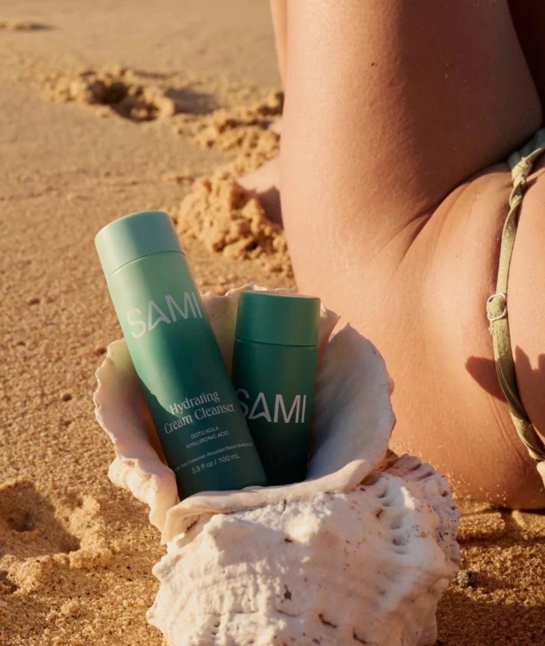 Hydrating Cream Cleanser by SAMI — bottle inside seashell on beach sand | gentle soothing cleanser
