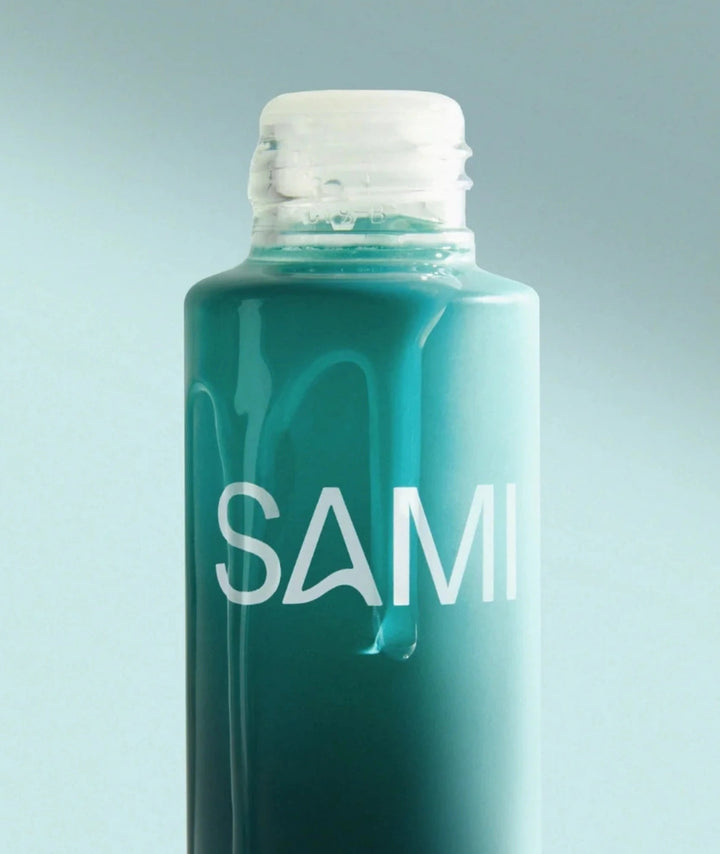 Close-up of SAMI Nourishing Oil Cleanser bottle displaying silky liquid oil texture and cap.
