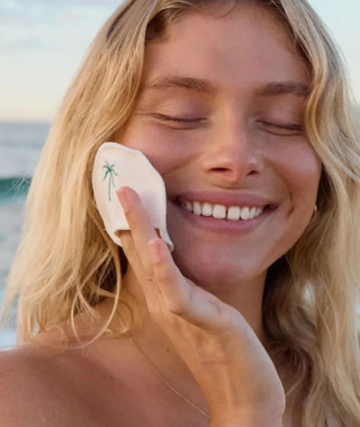 Reusable Cotton Rounds by SAMI — woman applying cotton pad to face at beach | soft makeup removing pad