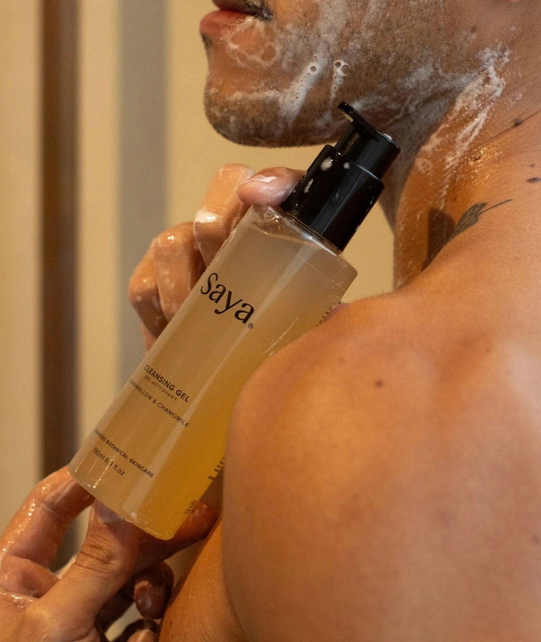 Model cleansing skin with Saya Cleansing Gel, a botanical face wash with marshmallow and chamomile.