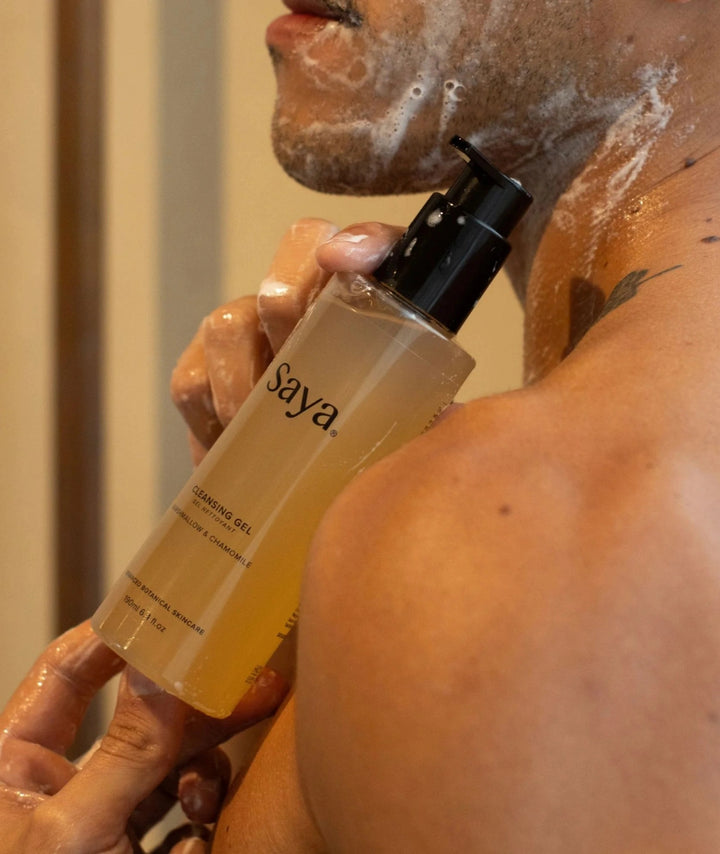 Model cleansing skin with Saya Cleansing Gel, a botanical face wash with marshmallow and chamomile.