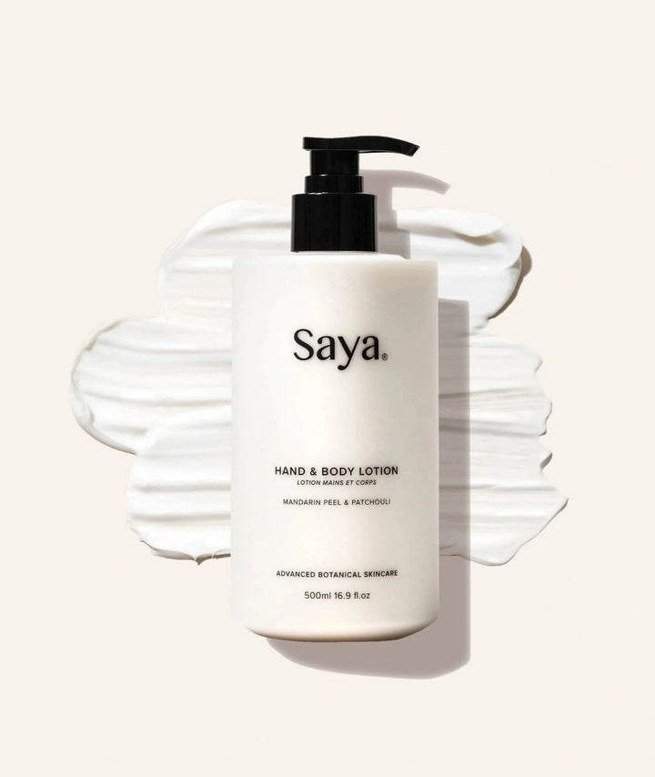 Saya Hand & Body Lotion bottle displayed on creamy white lotion smears.