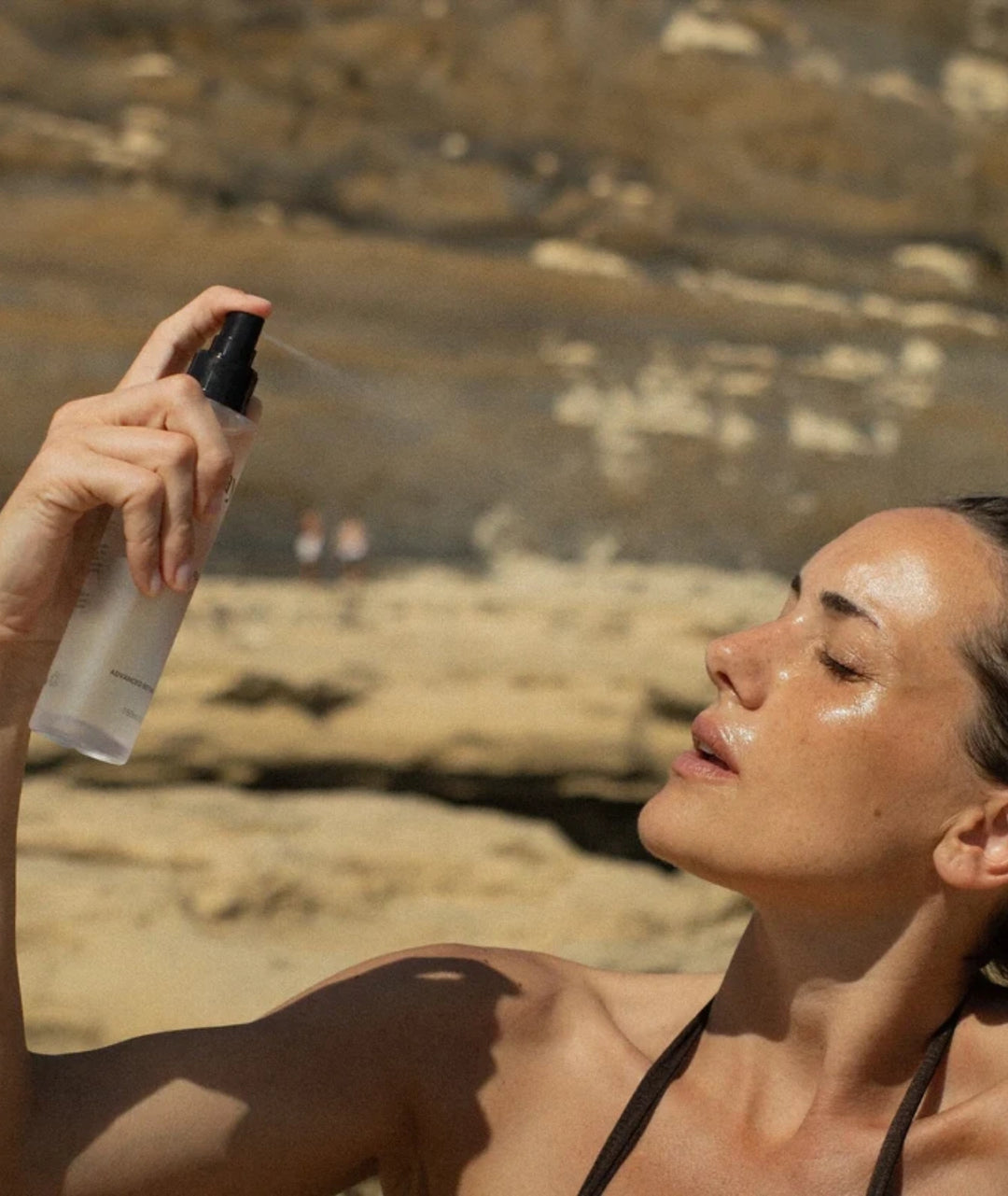 Model applying Saya Rose Hydrating Mist for instant hydration and refreshed, glowing skin outdoors.