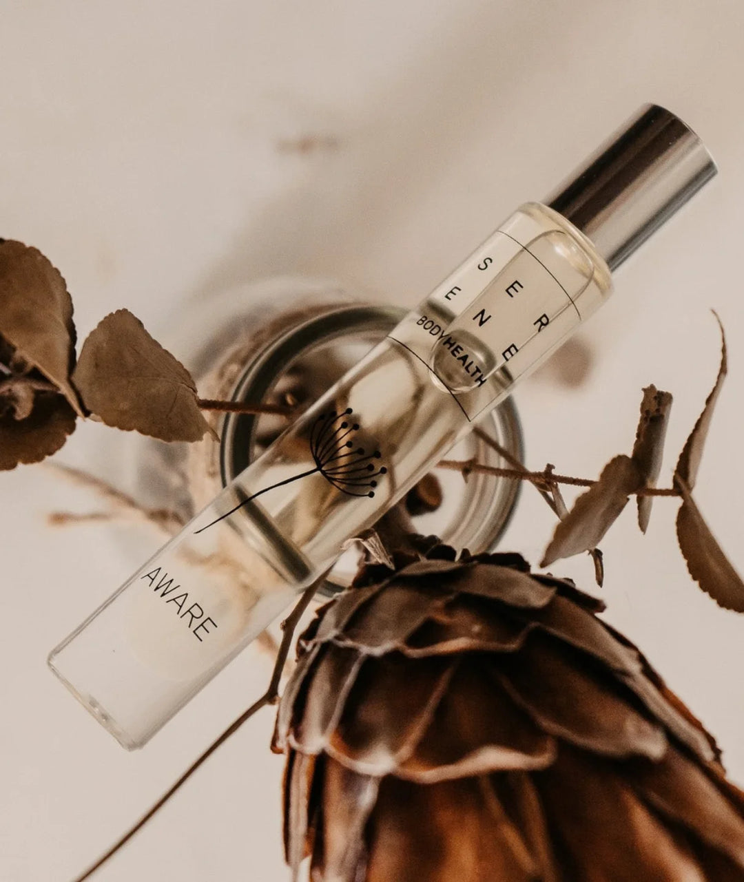 Aware Essential Oil by Serene Bodyhealth — rollerball resting on natural botanicals | Pure plant ingredients