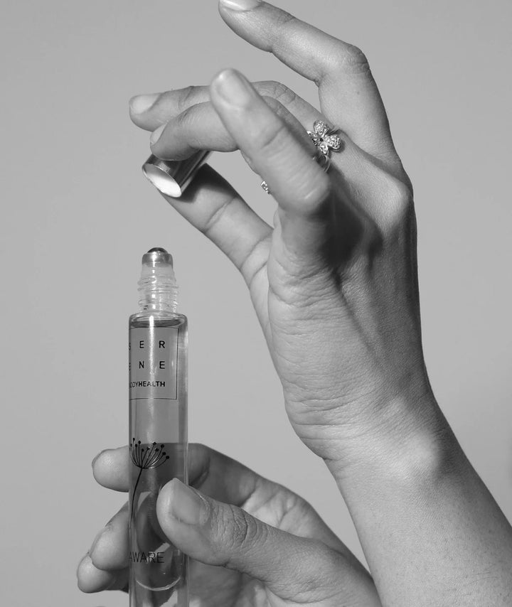Aware Essential Oil Rollerball by Serene Bodyhealth — hands opening the cap | Portable aromatherapy